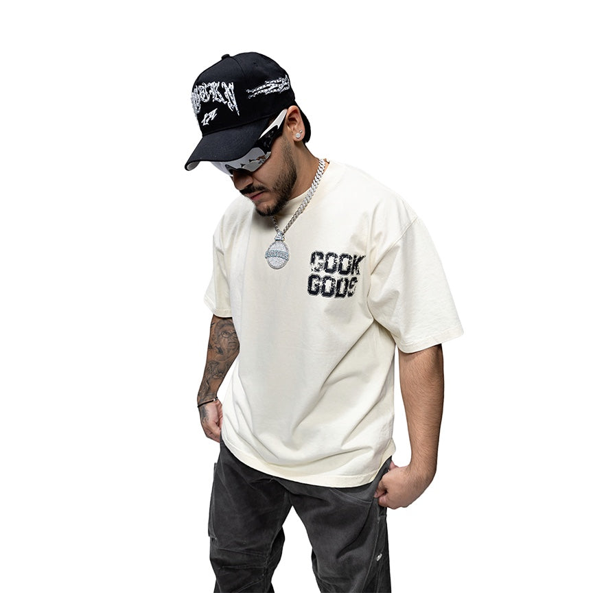 Cook Gods cream 100% USA cotton heavyweight t-shirt with oversized fit and black graphic logo on chest.