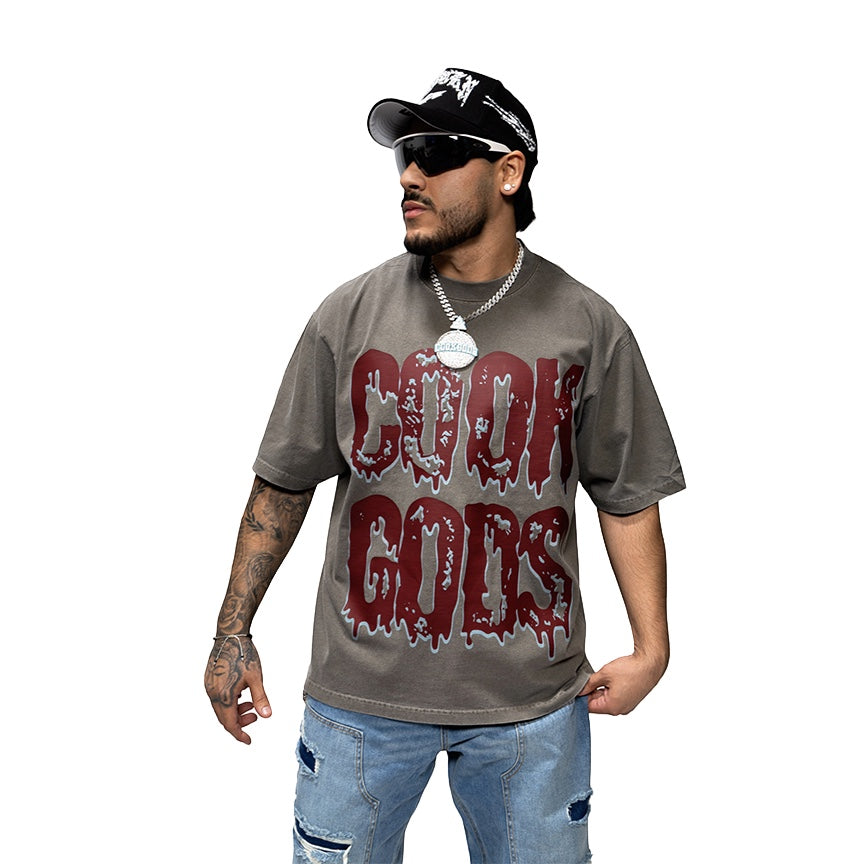 Cook Gods grey cotton t-shirt with a dripping logo graphic. Relaxed fit, crew neck, short sleeves.