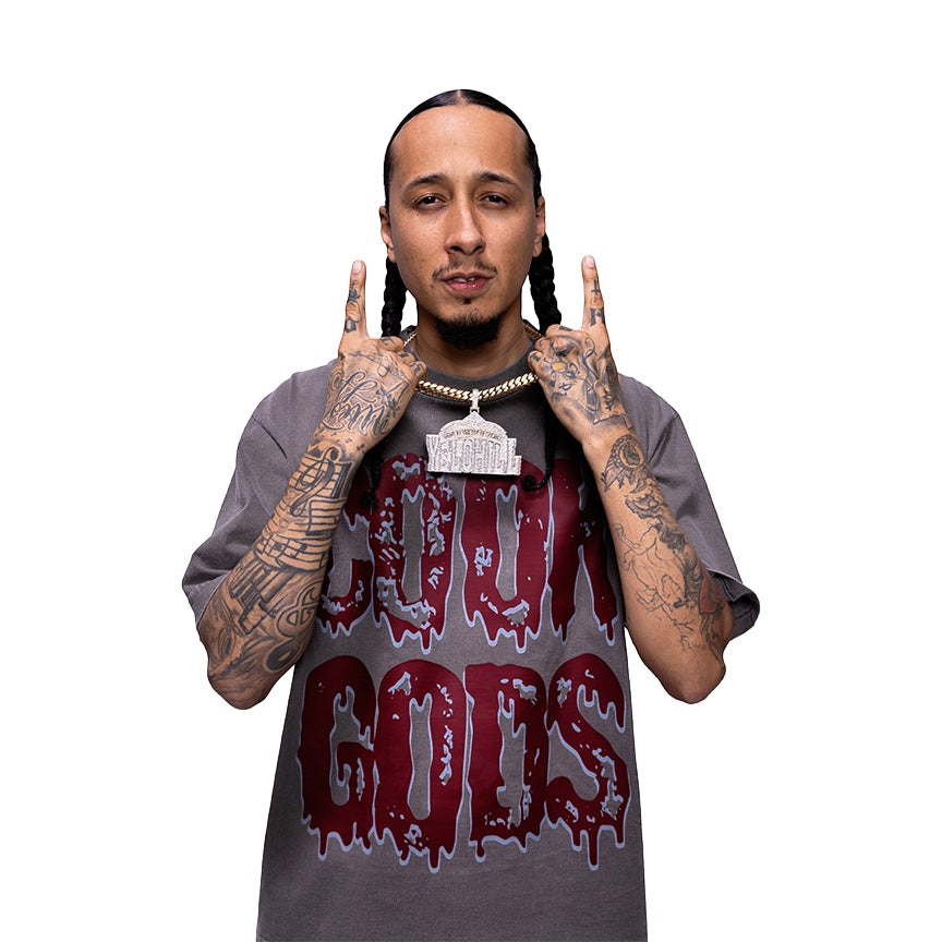 Cook Gods grey cotton t-shirt with a dripping logo graphic and a large iced-out pendant necklace.