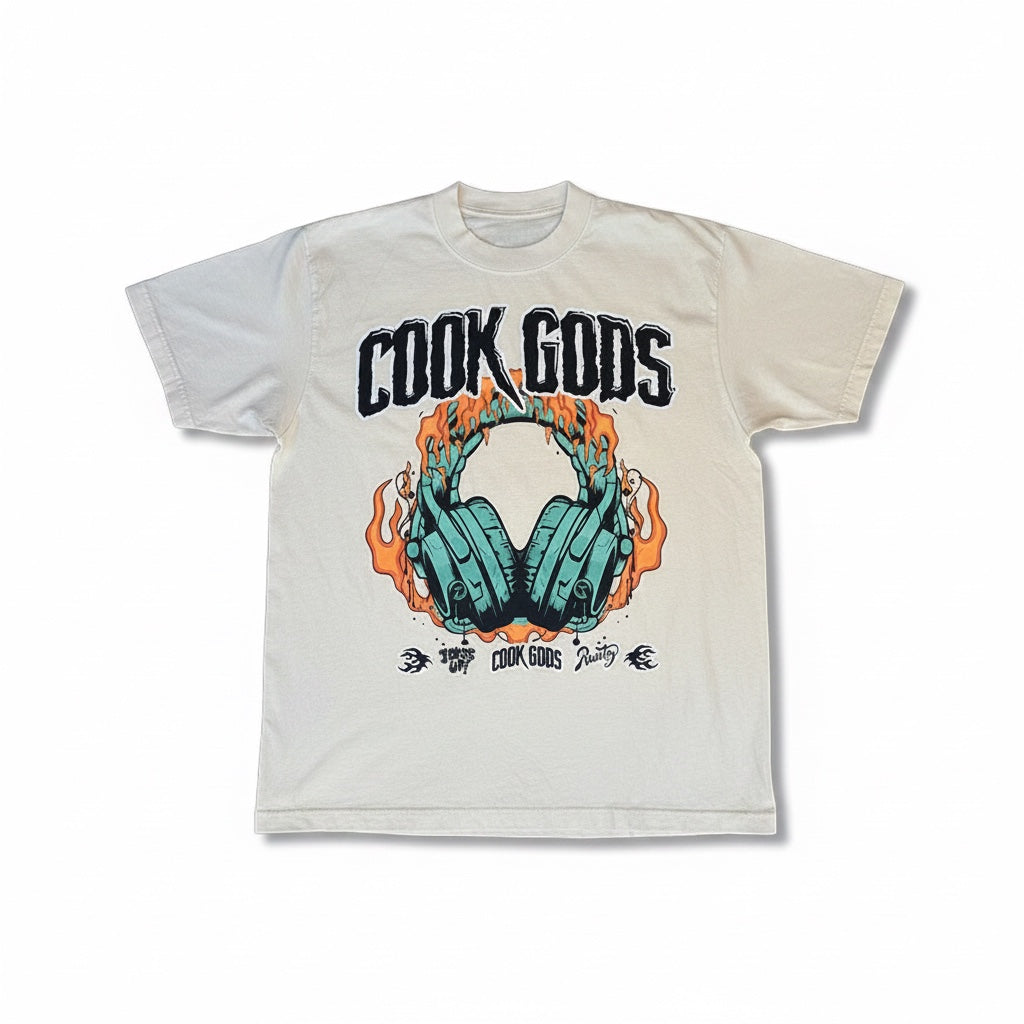 Cook Gods graphic t-shirt with teal headphones on fire and gothic logo. Cream cotton.