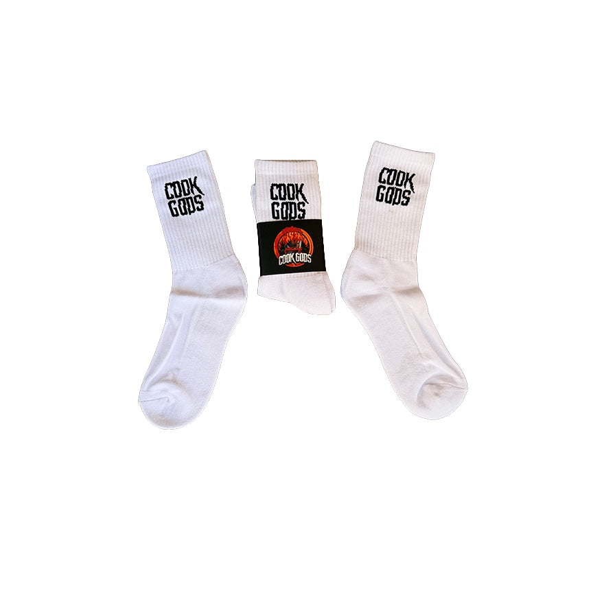 Cook Gods white crew socks with black logo detail. One pair is folded, showing the logo band.